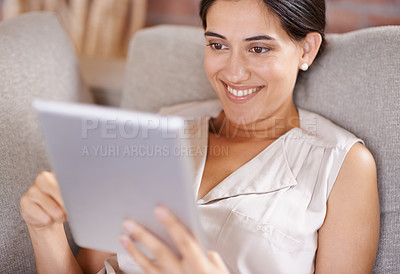 Buy stock photo Happy woman, tablet and relax for online entertainment, streaming or social media on living room sofa at home. Female relaxing with smile using technology for app or research lying on lounge couch