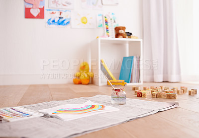 Buy stock photo Shot of children's painting supplies on the floor of a child's bedroom