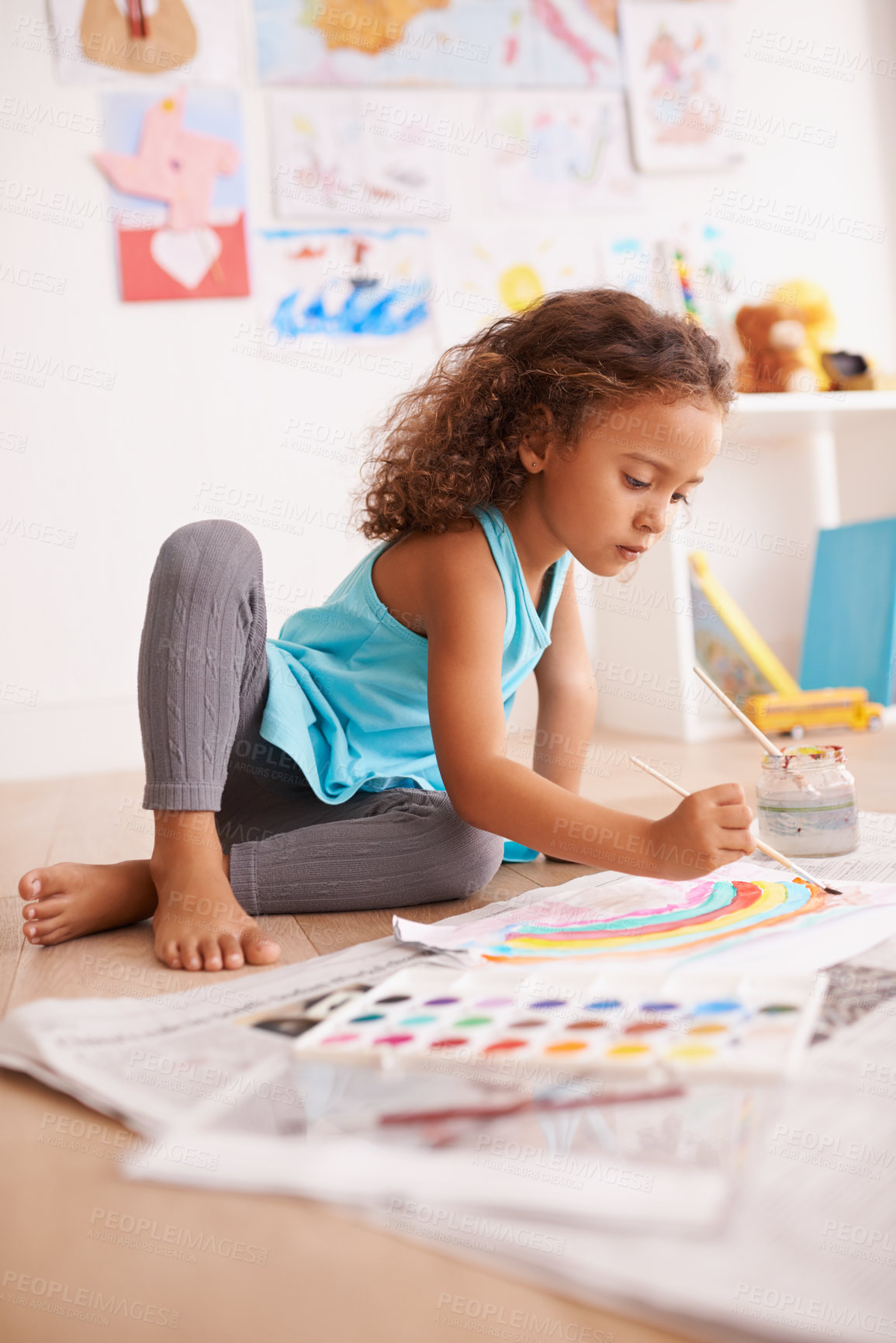 Buy stock photo Kindergarten, education or girl painting a rainbow on classroom floor for creative, learning or child development. Paper, color splash or sweet kid with school art paint, sketch or having fun drawing