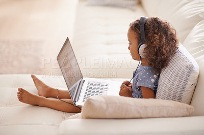 Buy stock photo Kindergarten, kid and elearning on laptop in home with online class, video and girl with headphones. Virtual, education and child with computer on sofa in house for development of language knowledge