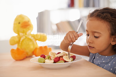 Buy stock photo Eating child, morning and fruit salad at home with breakfast and wellness meal and vitamins. House, nutrition and young girl with healthy food and fruits of a hungry kid with youth at a table 