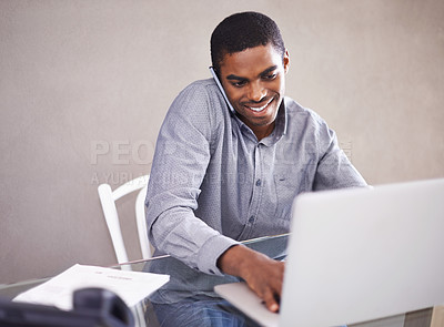 Buy stock photo Shot of a handsome young man working on his laptop at home