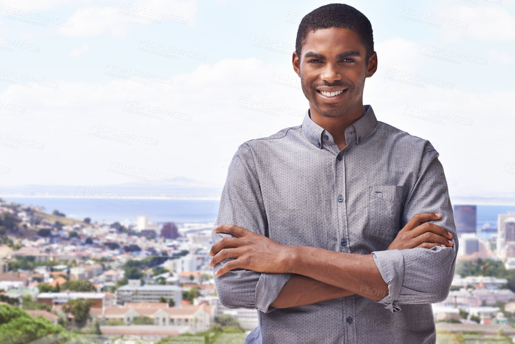 Buy stock photo Portrait of a handsome young man standing against a city backdrop