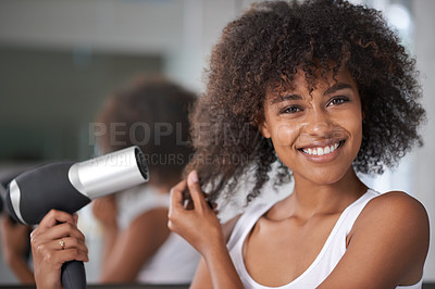 Buy stock photo Shot of an attractive young woman taking care of her hair