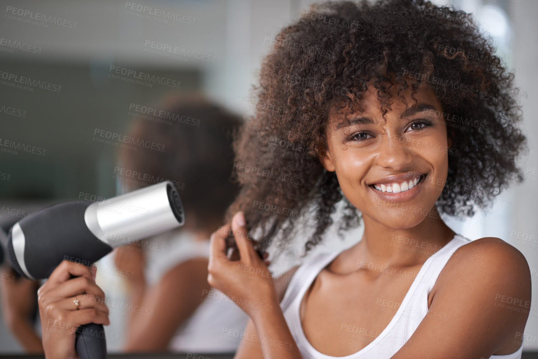 Buy stock photo Shot of an attractive young woman taking care of her hair