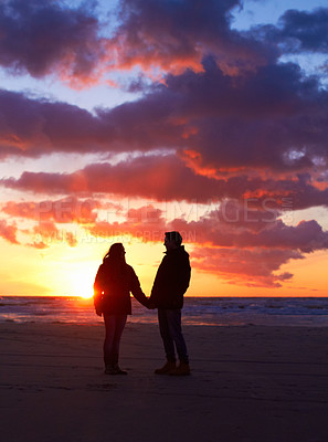 Buy stock photo Couple, silhouette and sunset sky at the beach on a romantic date, vacation or holiday in nature. Man and woman holding hands with love and care on travel, adventure or trip with clouds and ocean