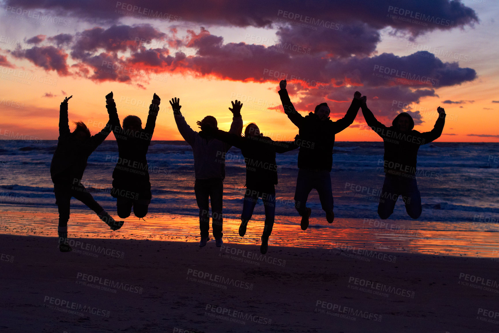 Buy stock photo Beach, sunset and silhouette of jumping friends in nature, freedom and celebrating travel outdoor. Shadow, jump and group of people at the ocean and sunrise for adventure, celebration or sea vacation