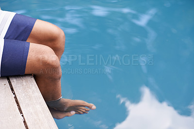 Buy stock photo Cropped shot of a man's feet in the water
