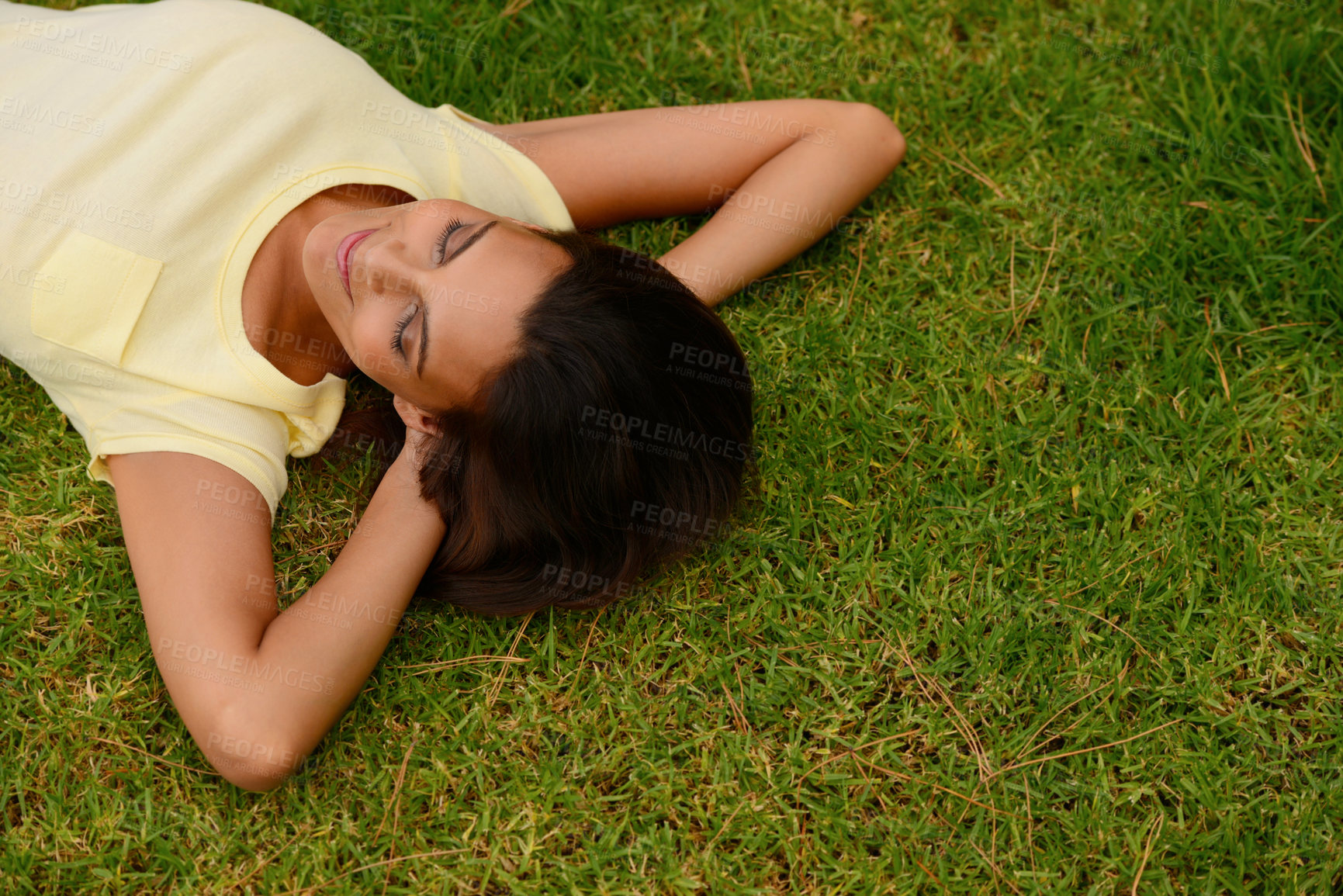 Buy stock photo Nature, garden and woman relaxing on the grass for fresh air, rest and daydreaming outside. Happy, freedom and young lady from Mexico with a smile lying on the green lawn in an outdoor park or field.