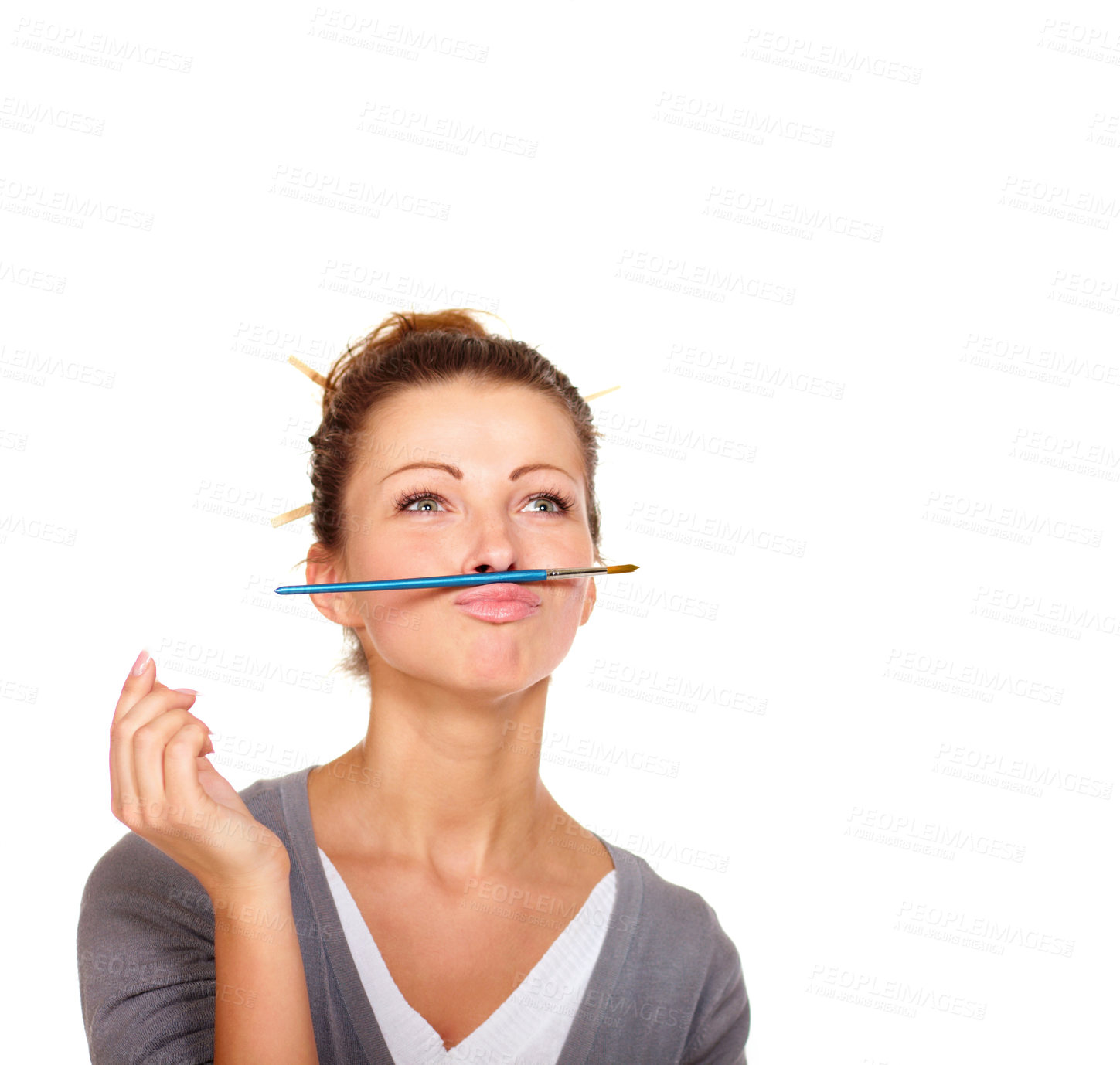 Buy stock photo Studio shot of an attractive woman balancing a paint brush on her upper lip