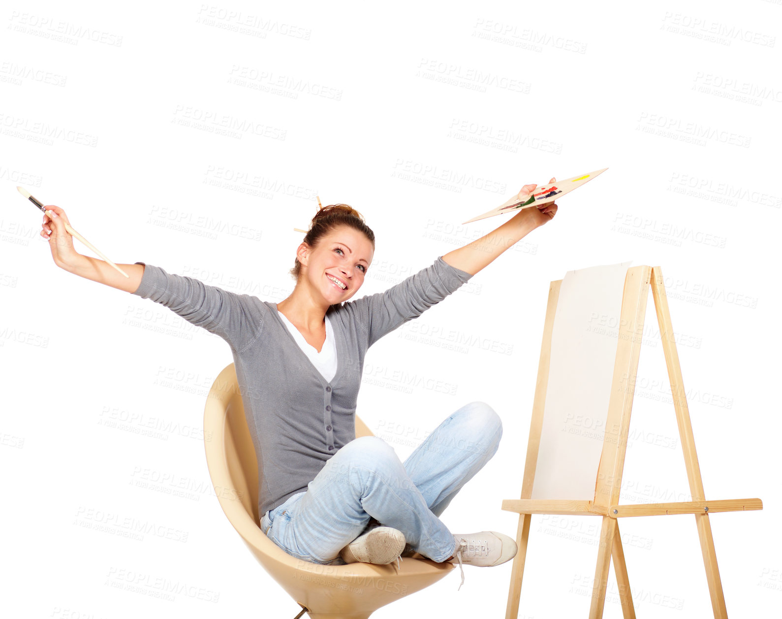 Buy stock photo Studio shot of a young woman holding a palette and brush looking for inspiration 