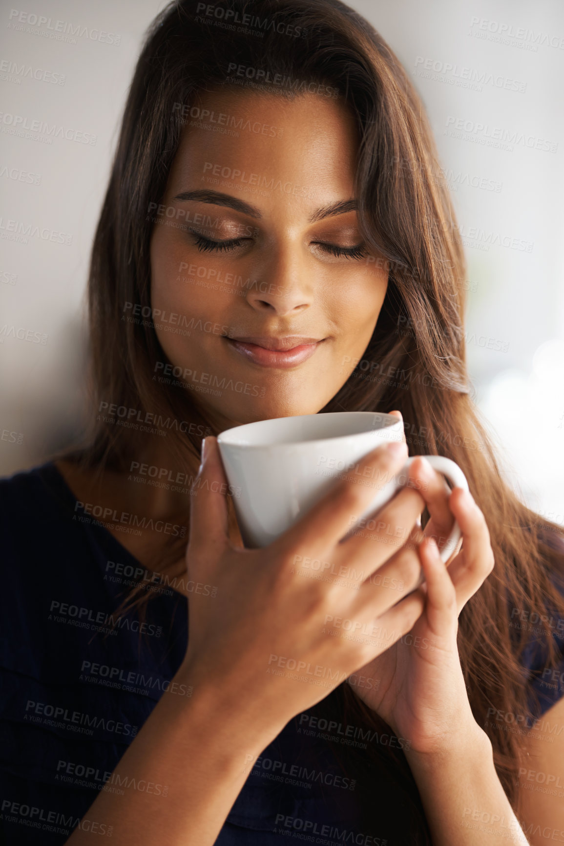 Buy stock photo Shot of an attractive young woman drinking a coffee at home