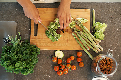 Buy stock photo Hands, knife and above for vegetables in kitchen with chopping, asparagus and cooking with nutrition for dinner. Chef, person and meal prep with vegan diet for food, wellness and lunch in apartment