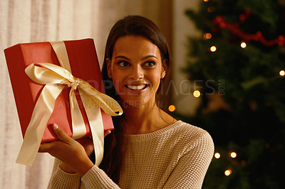 Buy stock photo Christmas, gift and excited woman, box and happy smile with ribbon, holiday and celebration in home. Surprise, happiness and present package with happiness, young female and tree with in background