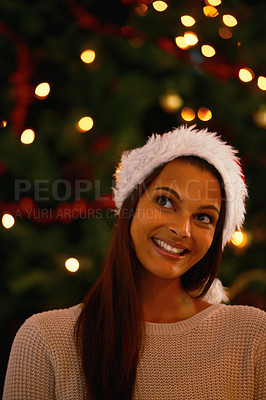 Buy stock photo Happy woman, home and idea for gifts by christmas tree, love and giving in holiday season for care. Young person, smile and excited or inspiration for present and celebration with kindness in house
