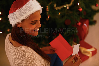 Buy stock photo A young woman in front of a Christmas tree