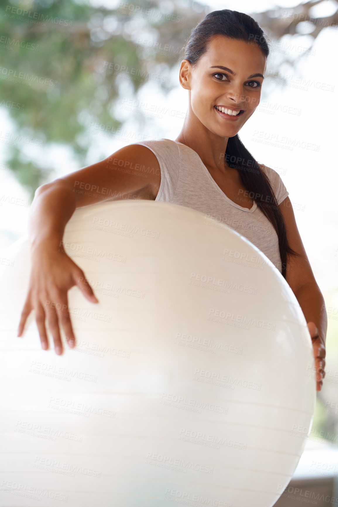 Buy stock photo Portrait of an attractive young woman holding an exercise ball