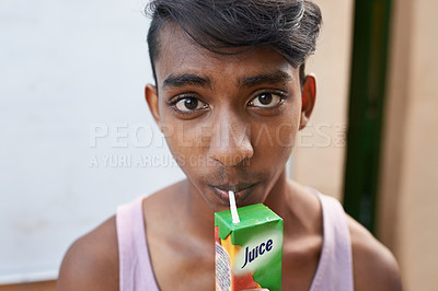Buy stock photo Portrait, teenager and drinking juice outdoor for healthy diet, wellness or nutrition in India. Face, boy and beverage with straw in box for benefits, energy and organic liquid fruit for hydration