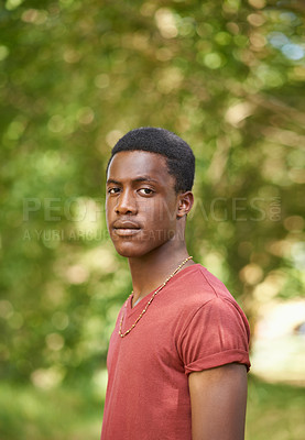 Buy stock photo Portrait, teen boy and outside in garden with bokeh blurred background or African teenager, nature and outdoor, park or summer. Young person, serious face and green, trees or spring sunshine