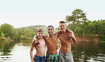Buy stock photo Portrait, hug and friends happy in swimwear by lake, river and water outdoor in nature, landscape and forest. People, teenage boys and diversity on vacation, holiday and camping trip for summer