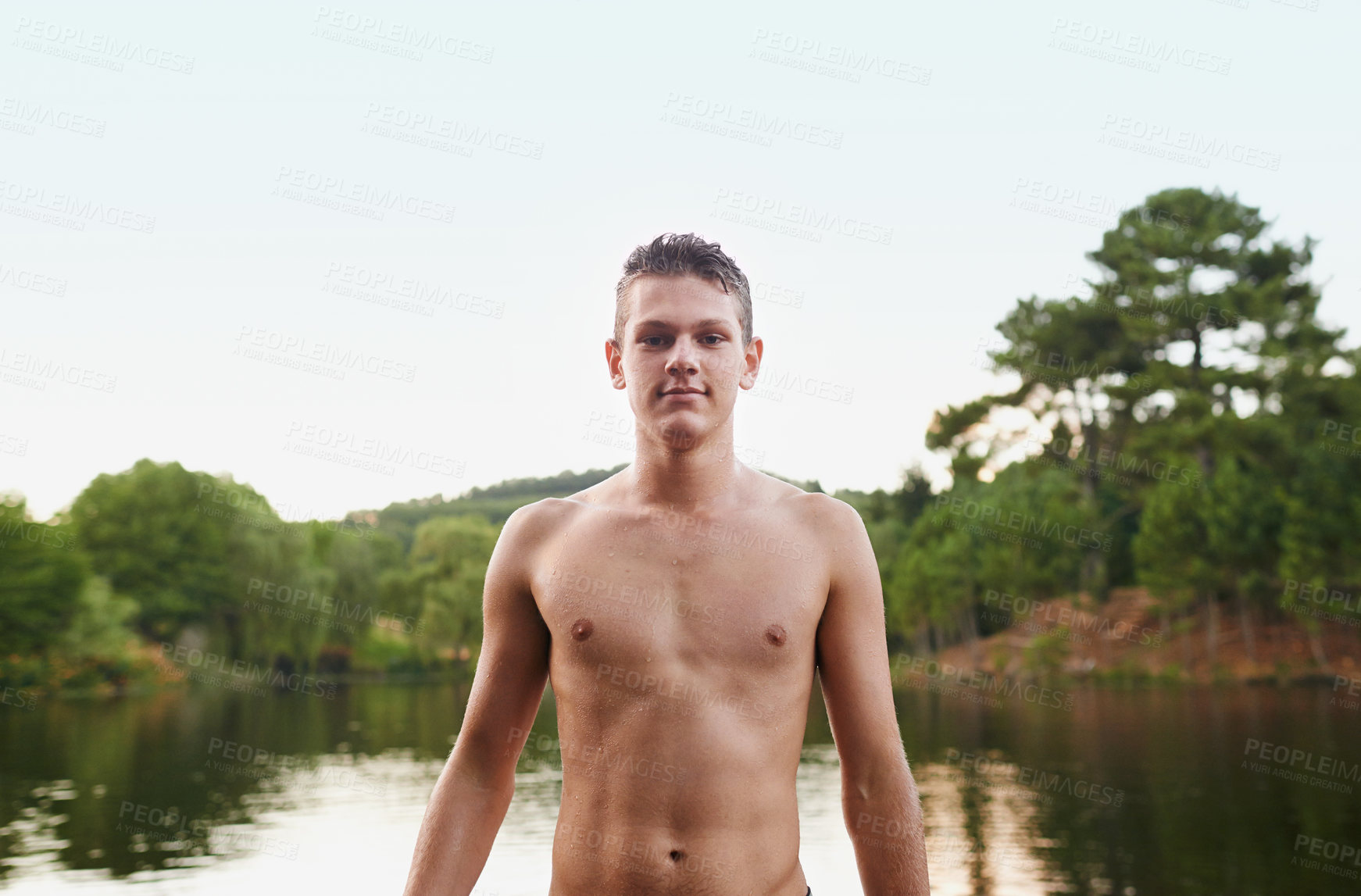 Buy stock photo Portrait, lake and teenager swimming in water for adventure, summer vacation and sunshine in nature. River, outdoor and face of male person for holiday, getaway trip and fresh air in countryside