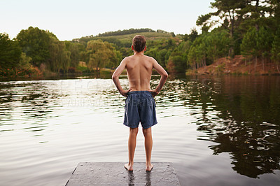 Buy stock photo Lake, pier and person in nature for summer adventure or relax on holiday and vacation in countryside. River, water and back of boy standing on deck with confidence and enjoy environment of forest