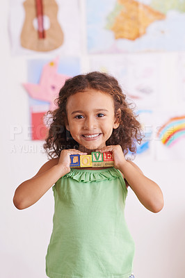 Buy stock photo Girl, smile and learn with blocks in portrait, child development and growth with letters. Female person, kid and abc or alphabet for language, kindergarten and creative game for education at school