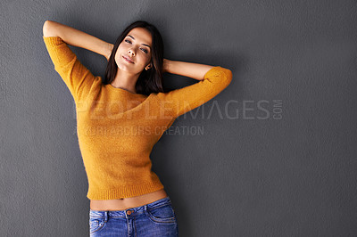 Buy stock photo Shot of a beautiful young woman against a gray background