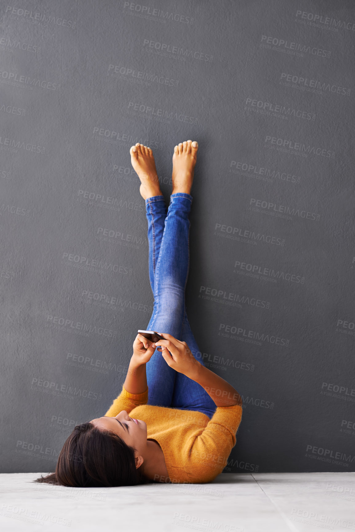 Buy stock photo Wall, feet up or woman with phone relax on floor with social media, scroll or web communication on grey background. Smartphone, search or lady person on ground with google it, app or Netflix sign up