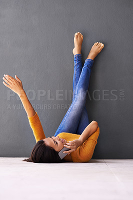 Buy stock photo Phone call, wall and happy woman with smile, floor and elevated with conversation on cellphone. Technology, communication or social female person on ground, legs up and mobile with mockup space