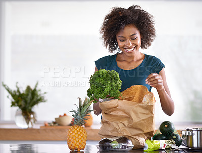 Buy stock photo Cropped shot of a young woman with some groceries