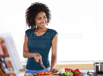 Buy stock photo Cooking, happy woman and cutting vegetables in kitchen with recipe book for healthy diet, nutrition or mockup. Chopping board, food and African person thinking of dinner or organic meal prep in home
