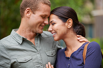 Buy stock photo Cropped view of a happy young couple standing together out in the park