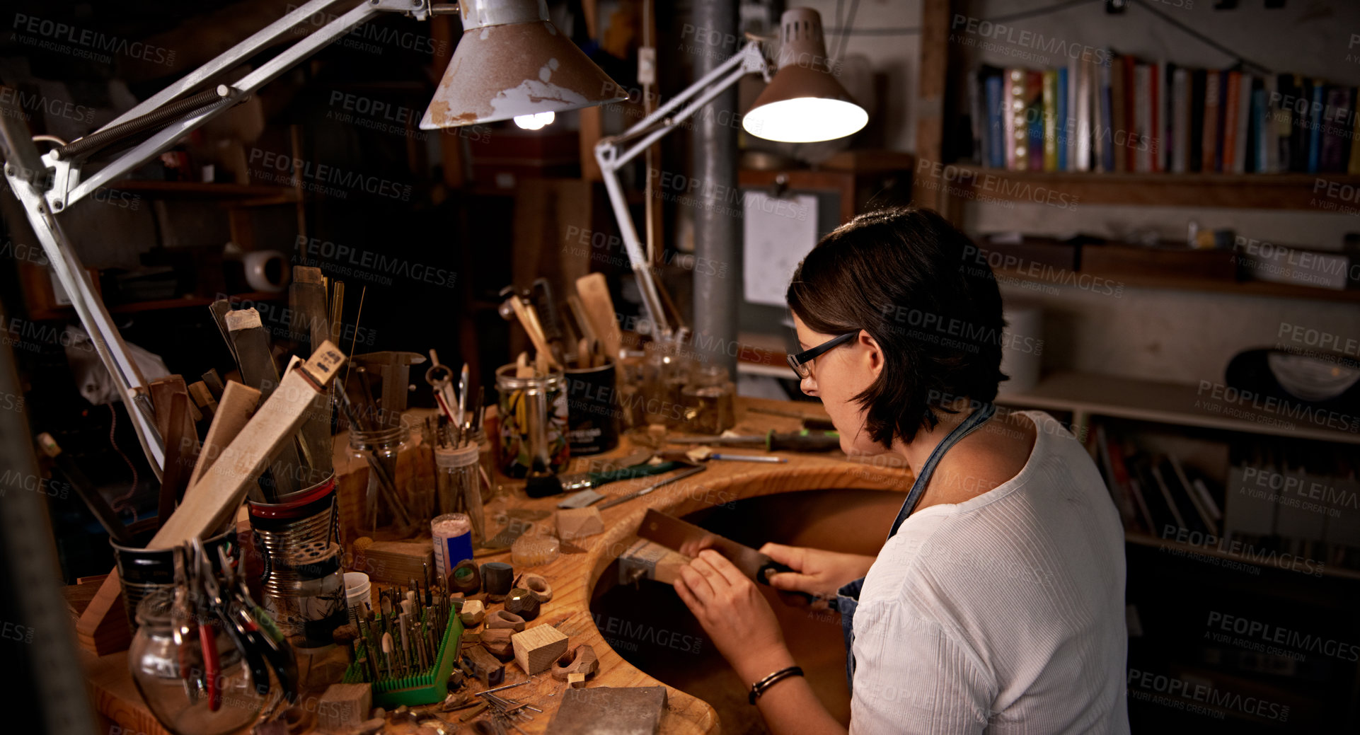 Buy stock photo Artist, woman and cutting with wood in workshop for craftsmanship, skill or handmade design with creativity. Woodwork, carpenter or creative person at workspace with equipment for handicraft or hobby