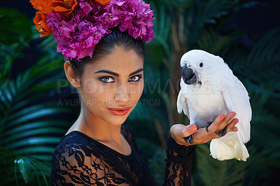 Buy stock photo Jungle, portrait or woman with flowers, bird or natural cosmetics for wellness in nature aesthetic. Outdoor, face or female Indian model in rainforest for skincare beauty, pet animal or floral art