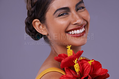 Buy stock photo Studio, woman and portrait with flower for makeup, cosmetics and floral beauty with smile. Happy, Indian person and face with dermatology for luxury, wellness and sustainability on purple background
