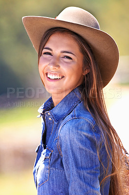 Buy stock photo Happy woman, portrait and cowgirl with hat on farmland for adventure, travel or outdoor journey in Texas. Female person with smile in western fashion, denim shirt and cap at ranch in the countryside
