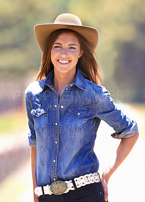 Buy stock photo Happy woman, portrait and cowgirl with hat on farm for adventure, travel or outdoor journey in Texas. Female person with smile in western fashion, denim shirt and cap at ranch in the countryside 