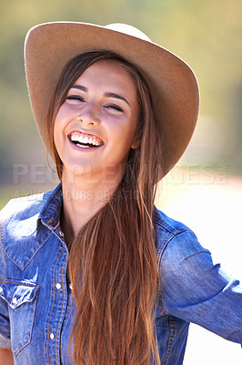 Buy stock photo Portrait, fashion and smile of cowgirl on farm or ranch for agriculture or sustainability in summer. Countryside, texas or western with happy young person in hat outdoor in field for organic farming