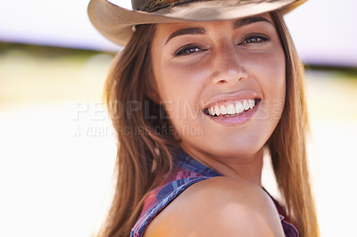 Buy stock photo Portrait, smile and cowgirl in hat on farm or ranch for agriculture or sustainability in summer. Countryside, texas or western with face of young farmer outdoor in field for organic or green farming