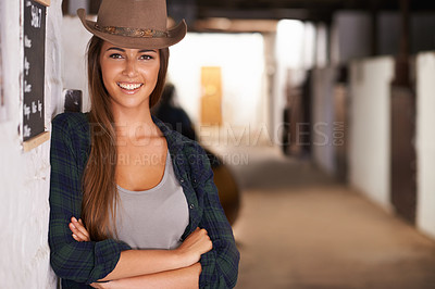 Buy stock photo Cowgirl or woman, confident and portrait in barn in rural or countryside for agriculture and summer adventure. Female cowboy or equestrian in stable or ranch with arms crossed in Western Texas.