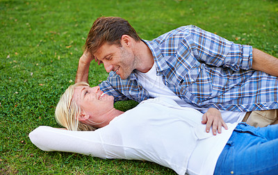 Buy stock photo Couple, relax on grass and bonding in park for love, trust in commitment and marriage. Happy people on date, together outdoor for fresh air and romance with support, loyalty and peace on picnic
