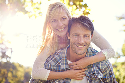 Buy stock photo Couple, portrait and smile in park with piggyback for love together on vacation or nature explore, sunshine or relax. Man, woman and face for holiday in environment for date happiness, summer or trip