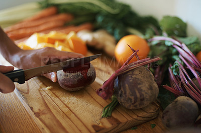 Buy stock photo Cropped shot of a woman slicing fruit and vegetables on a chopping board