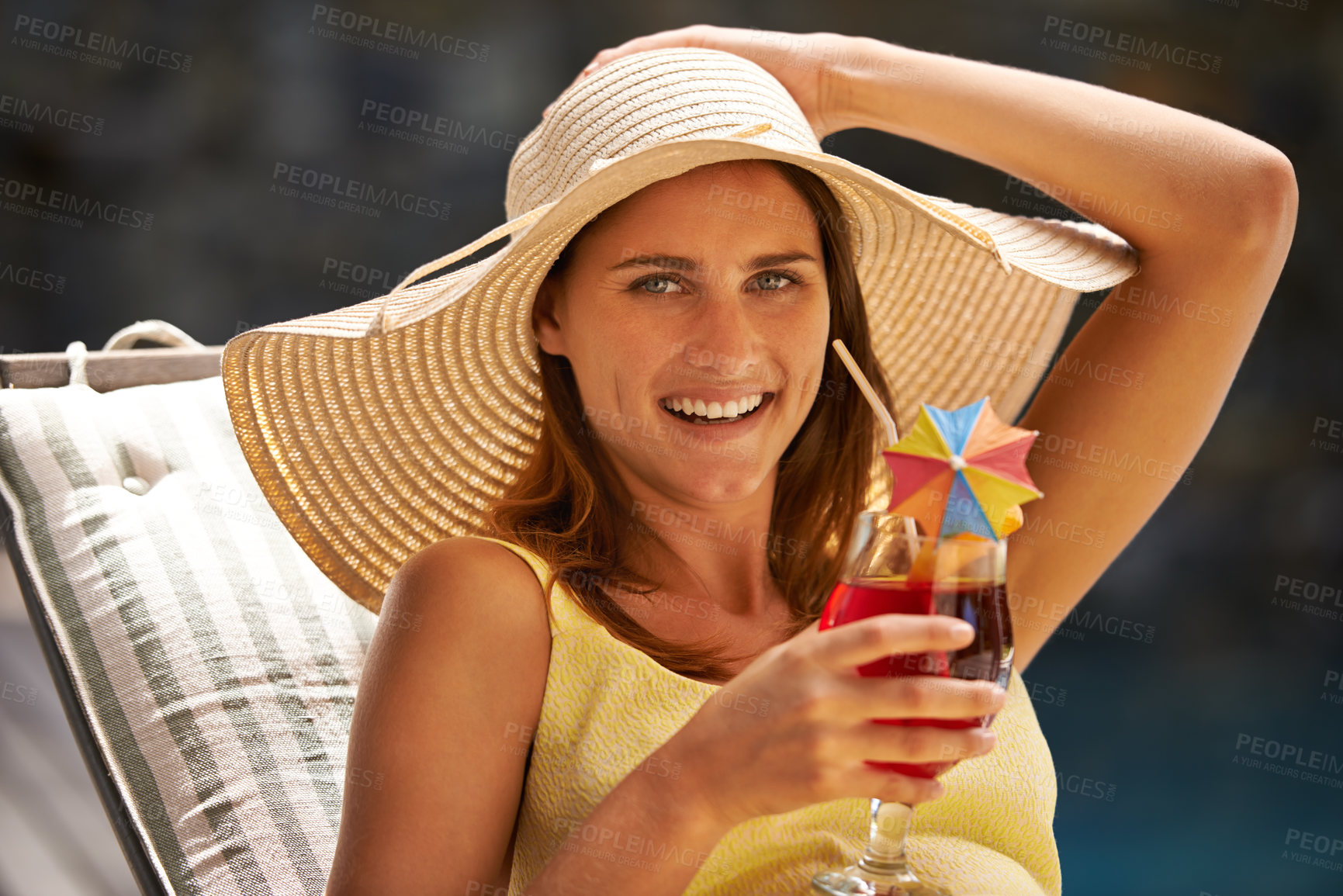 Buy stock photo Woman, cocktail and drink by swimming pool on lounge chair for summer, holiday and tropical vacation. Young person or tourist in portrait by hotel with hat, glass or alcohol for happy, outdoor break