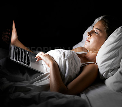 Buy stock photo Bed, laptop and night with woman streaming content, video or browsing social media in dark home. Bedroom, computer and subscription with young person in apartment to relax on weekend time off