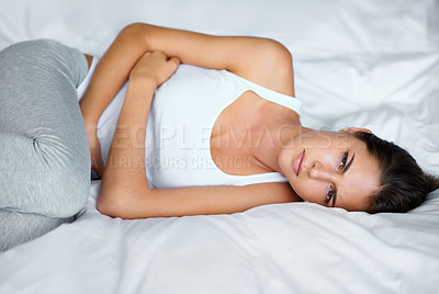 Buy stock photo Woman, stomach ache and pain in bed with digestion issue, menstruation cramps or endometriosis. Gut health crisis, colon blockage or constipation with bloating from stress, PMS or gastro at home