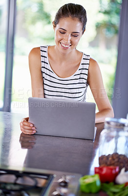 Buy stock photo Woman, happy and laptop on kitchen counter, female person and home on internet. Google it, browsing cooking recipes and social media, online search with technology for organic and healthy food ideas