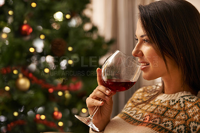 Buy stock photo Christmas, smile and wine with woman in living room of home, drinking alcohol to relax for celebration. Face, thinking and festive with happy young person in apartment for December holiday event