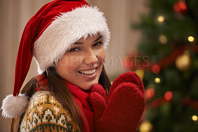 Buy stock photo Portrait, smile and woman in home for Christmas, party or holiday with gloves. Xmas, face and happy female person in hat for festive celebration, tradition and bokeh on tree in Spain in apartment
